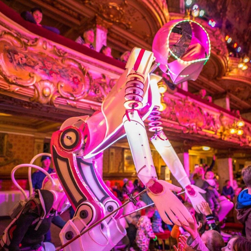 A pink glowing LED robot stilt walker