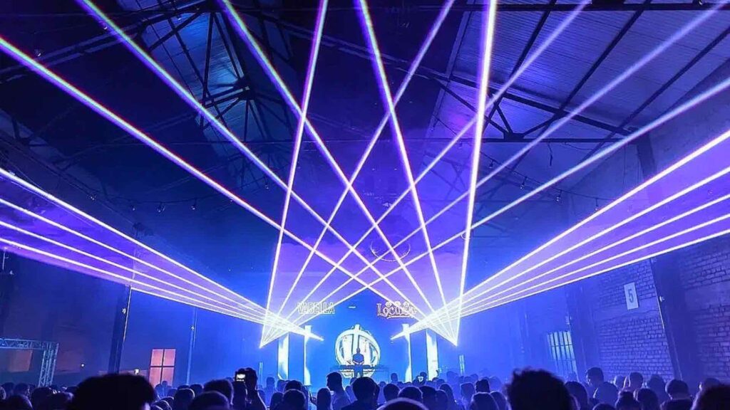 Pink laser beam system projecting from a vadella stage.