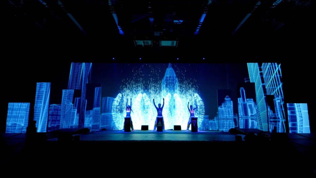 A blue LED screen graphic with an interactive drummer show