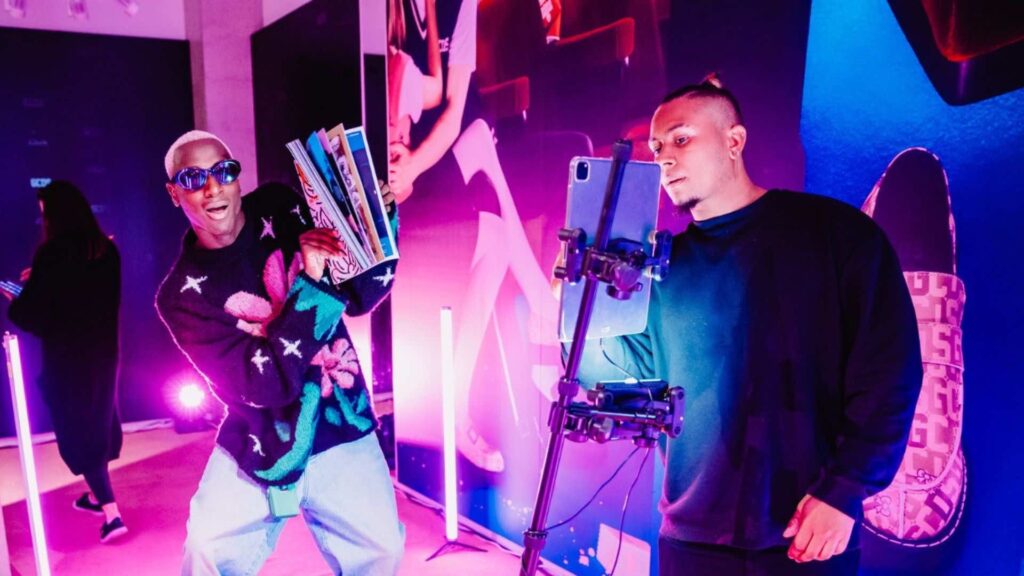 Two men take images on a 360 selfie booth