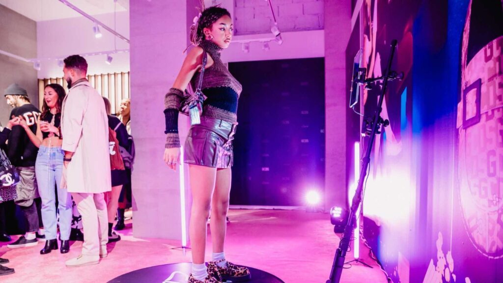 A lady stands on a social media photo booth that takes 360 images