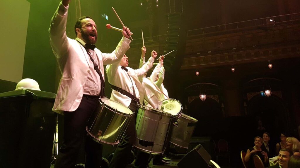 Drummers on stage perform on brazilian style drums