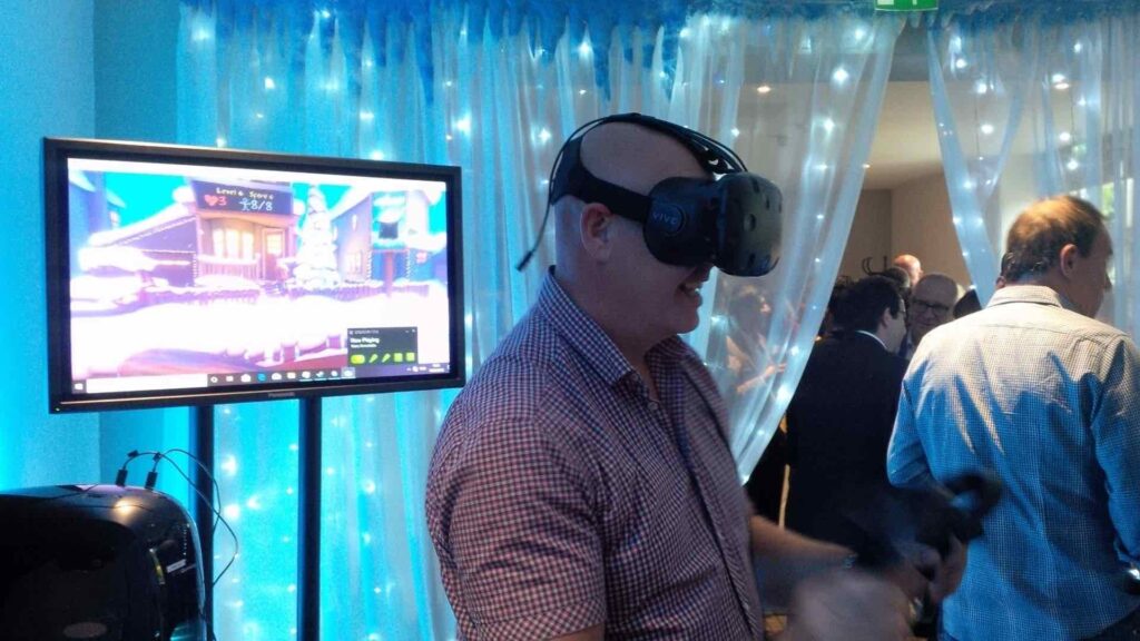 A man plays a virtual reality game through a headset device