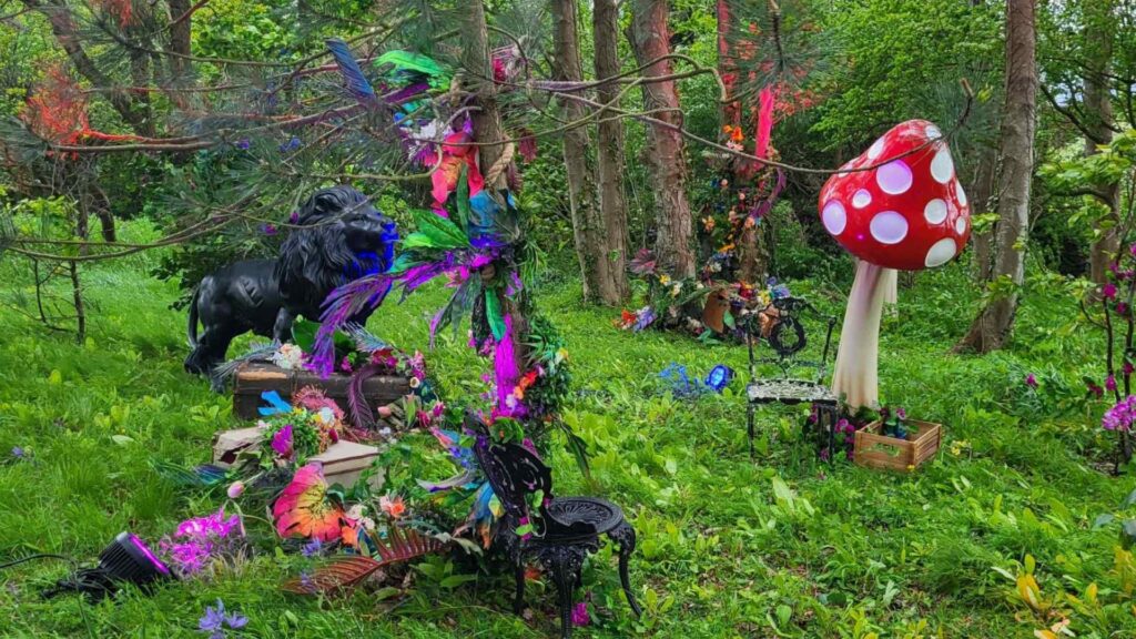 Range of enchanted garden props including red and white mushrooms, lion and foliage.