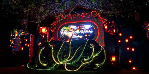 An immersive evening display of a 3D projection set design, drawing inspiration from an enchanted garden, brought to life with captivating illumination