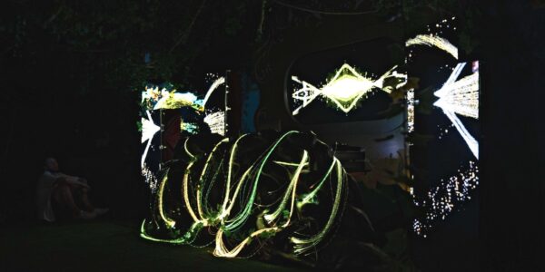 A whimsical 3D projection set design, inspired by the allure of an enchanted garden, beautifully lit up during the evening hours