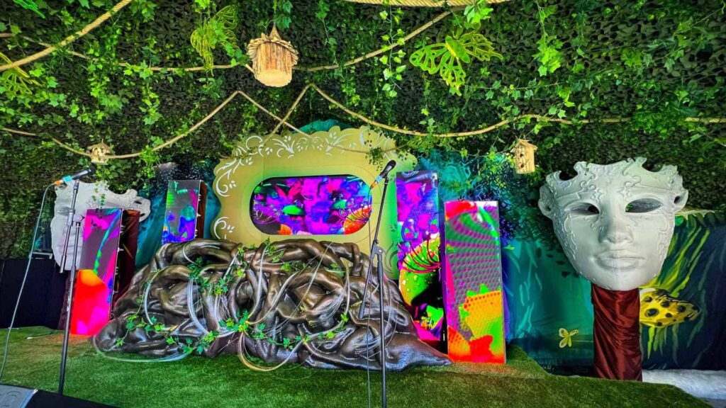 A bespoke set design featuring an enchanted garden theme used for performers and 3d projection