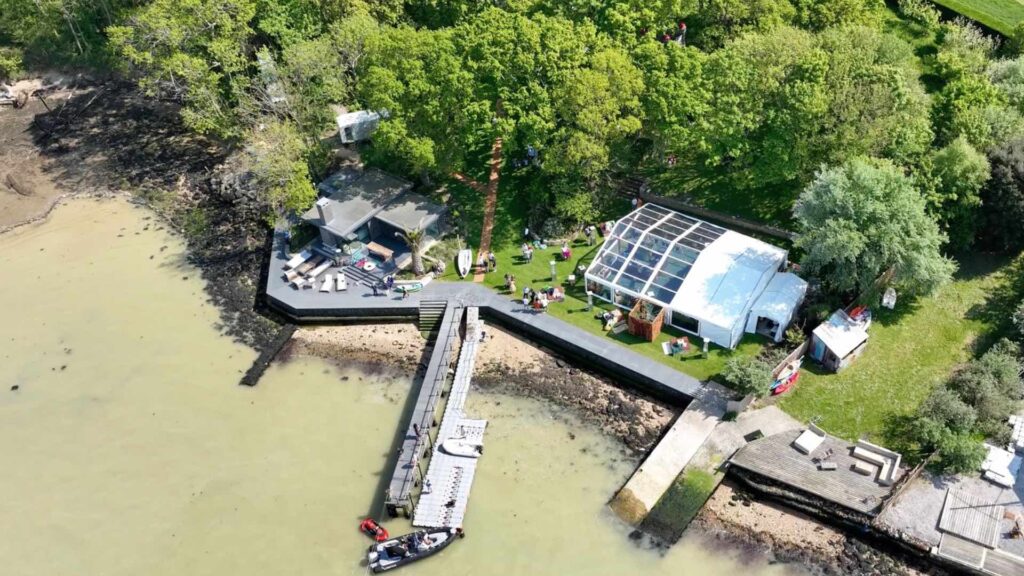 Aerial view of private island party showing clearspan marquee and pier.