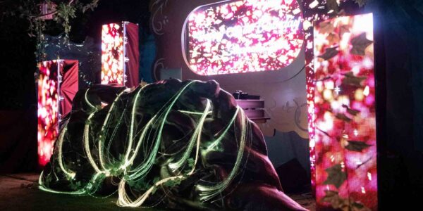 Marvel at a stage set design filled with enchanting custom props, perfectly blending with astonishing 3D projection to create a mesmerising garden-like ambiance.