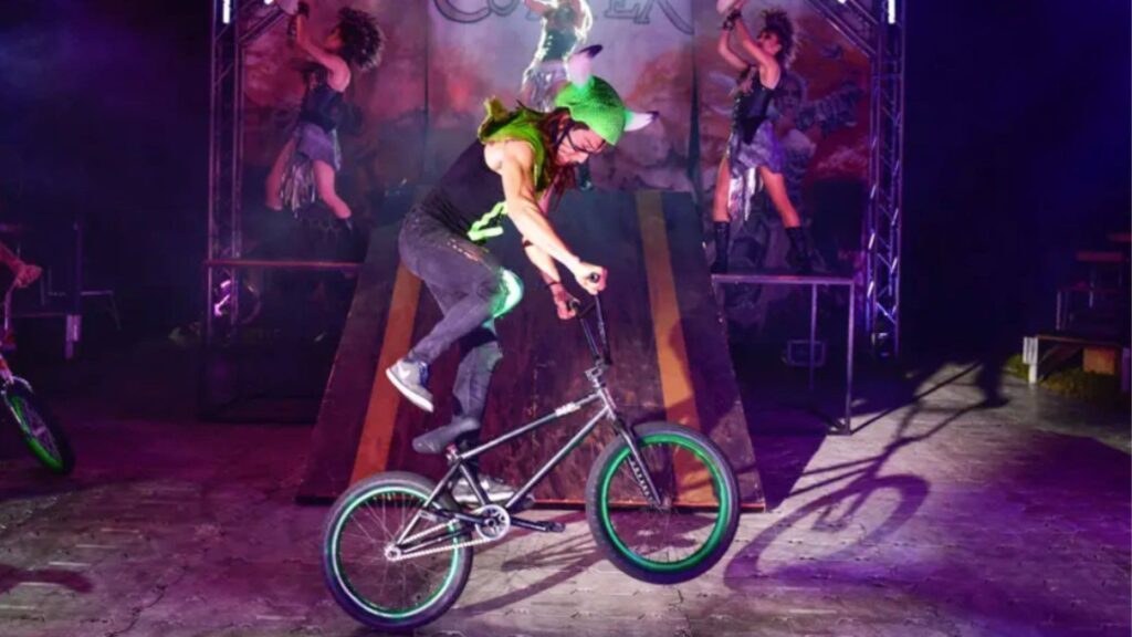 BMX stunt rider performs tricks during a circus show production