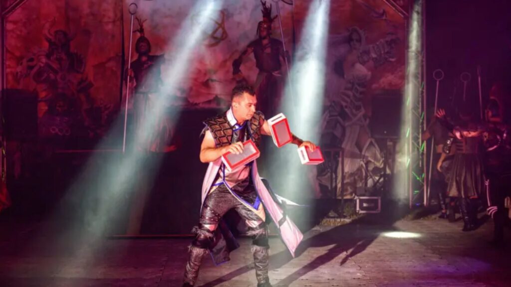 A modern circus show juggler performs for audiences