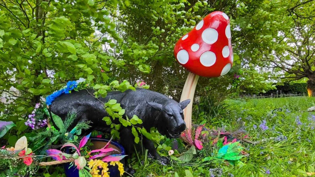 Enchanted garden themed event space with lion and mushroom props.