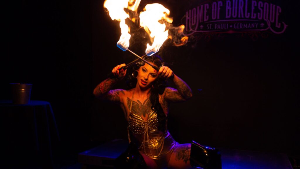 A female sword swallower who can also use fire in her act