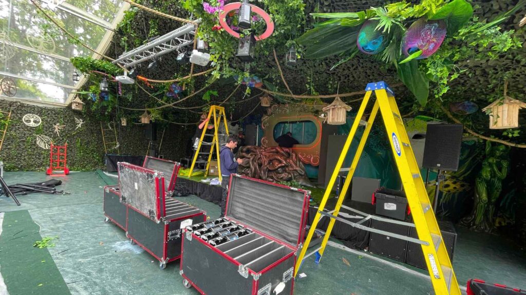 Team building stage inside enchanted garden themed marquee.