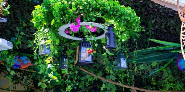 Green foliage ceiling decorations used within our marquee to enhance enchanted garden theme. We provided a range of bespoke hanging props and decorations as pictured here.