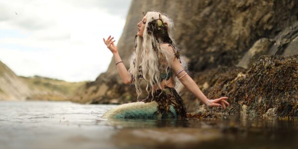 Mermaid-Entertainer-On-Rocks