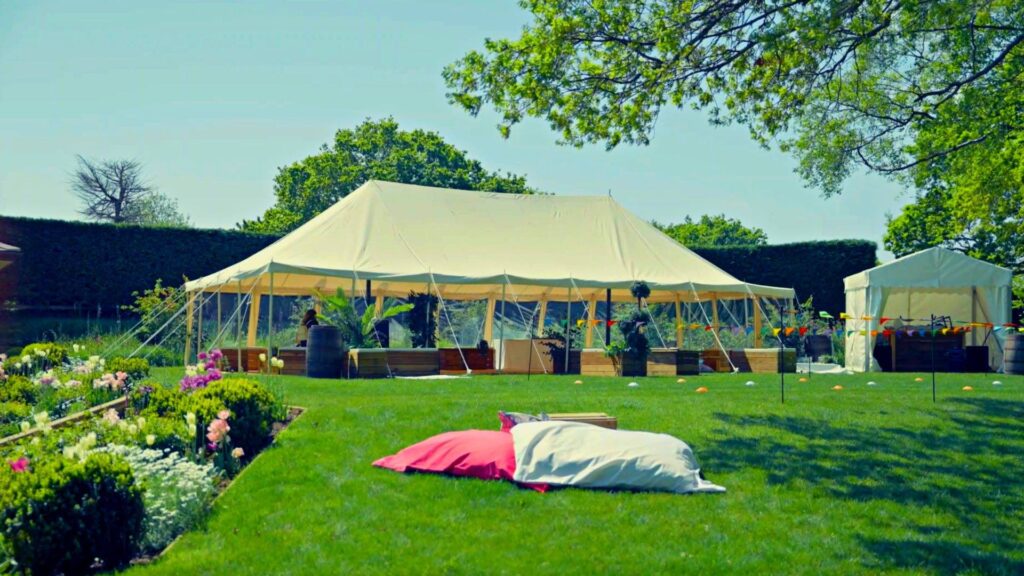 A relaxing vibrant landscape with beanbags to relax and marquee set for an enchanted garden event.