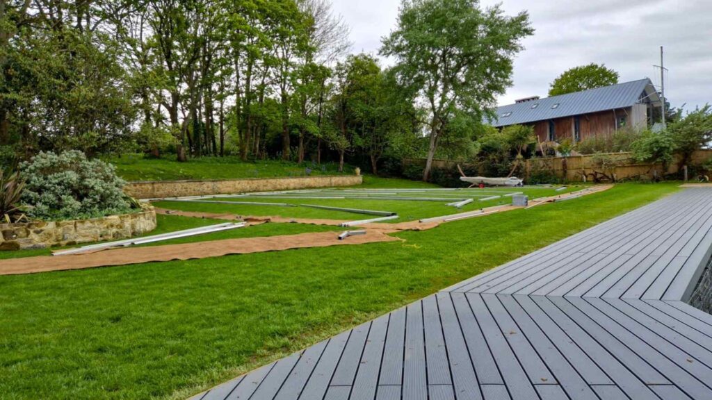 Large marquee being built on grass.