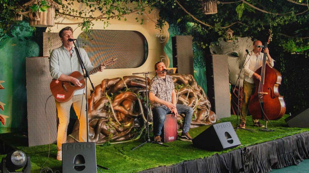 LIVE band performing on enchanted garden themed stage.