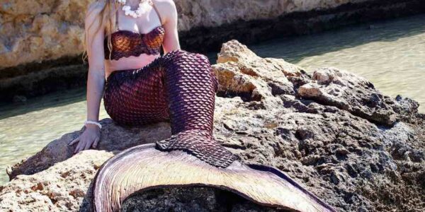Realistic-Mermaid-Peformer-On-Rocks