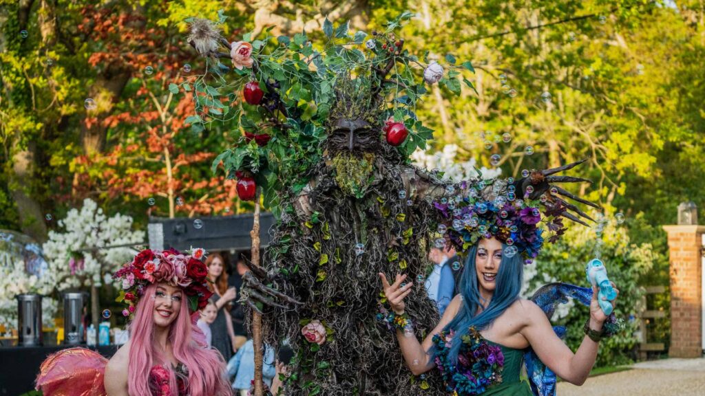 Spring themed entertainment featuring family fun day tree stilt walkers and enchanted fairy characters for walkabout entertainment