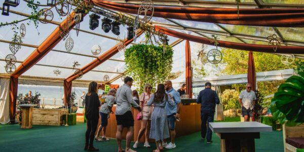 The interior of our enchanted garden marquee designed with a stunning central bronze bar and vibrant hanging foliage focal point