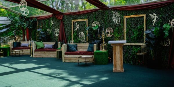 Our bespoke design set up for an enchanted garden theme featuring pallet furniture, earth tone draping and metallic props for bold impact