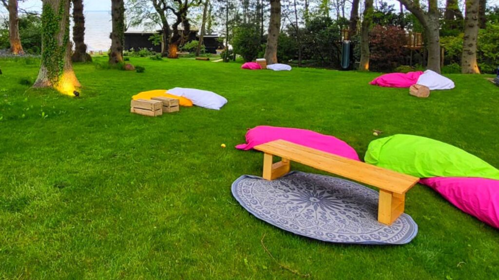 Bean bags and rugs on grass designed for guests to relax on