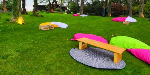 Set up your exterior space with comfortable blanketed and bean bag zones to encourage relaxation for your guests.