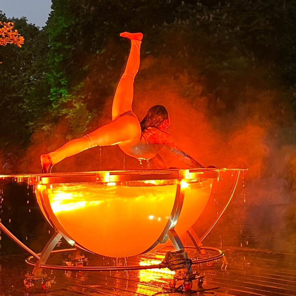 A water bowl performer performs a contortion act at a live event
