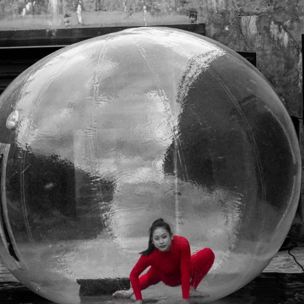 A see through bubble with contortionist inside