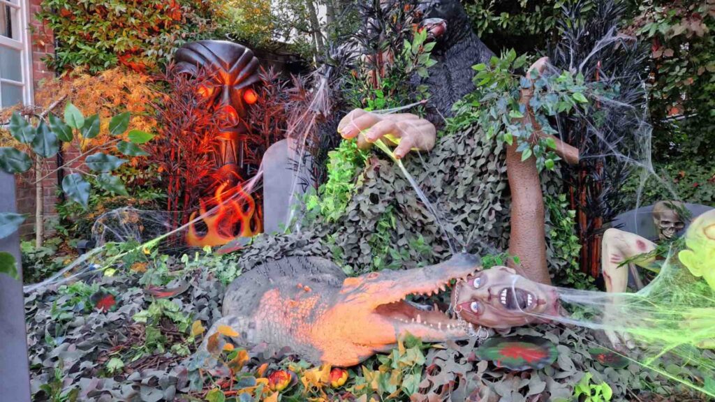 Jungle themed zombie Halloween props including crocodile eating a real zombie. Bespoke Event Decoration.