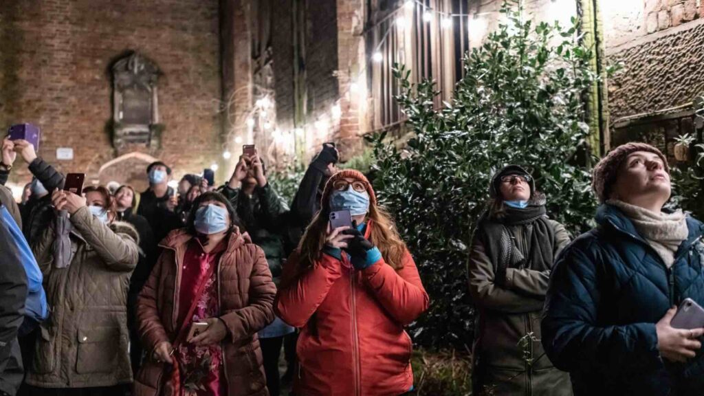 Spectators at Chinese New Year Eve looking at 3D projection.