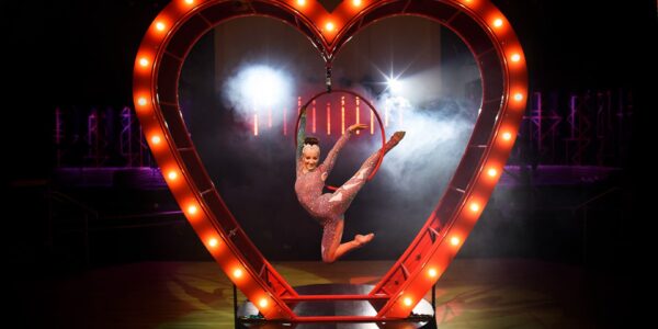 A giant aerial heart prop available for your event entertainment alongside graceful hoop performer