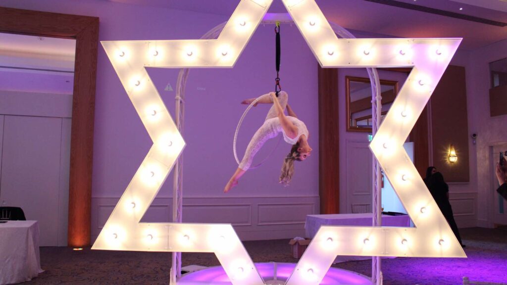 Captivating giant star hoop aerialist for corporate events.