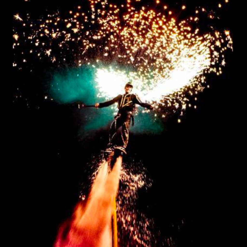 A bespoke show featuring a firework flyboard performer in the air.