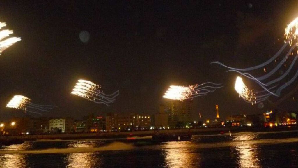 A bespoke pyrotechnic kite show over the water.