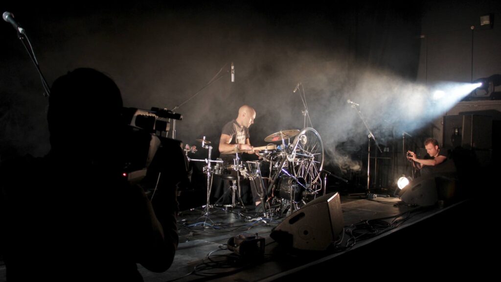 Bicycle drumming act performing on his bike drum kit.