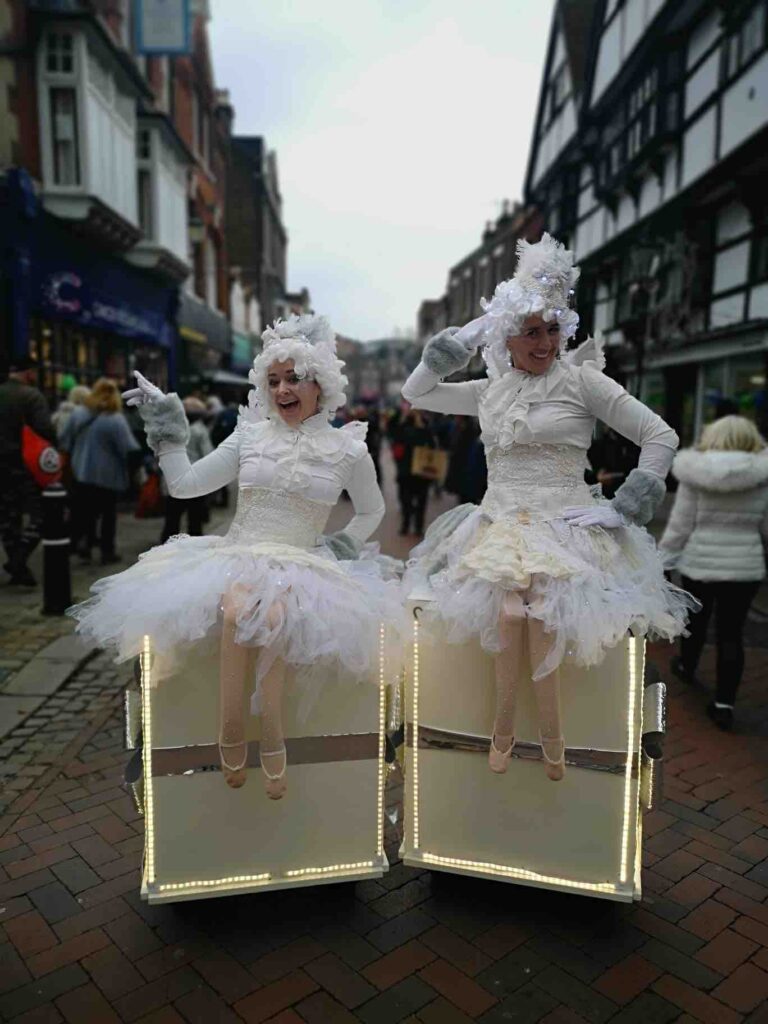 Duo of christmas angels for at a street festival christmas event