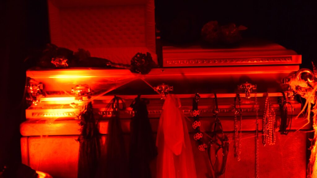 Cult Awakening Halloween Mansion Party coffin prop used in photo area.