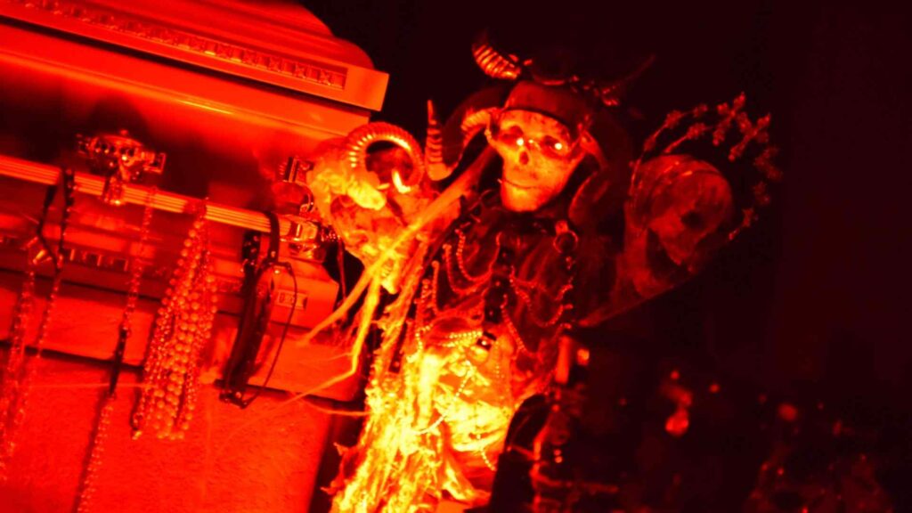 Close-up of Halloween skeleton prop used to decorate coffin photo area at Halloween mansion party.