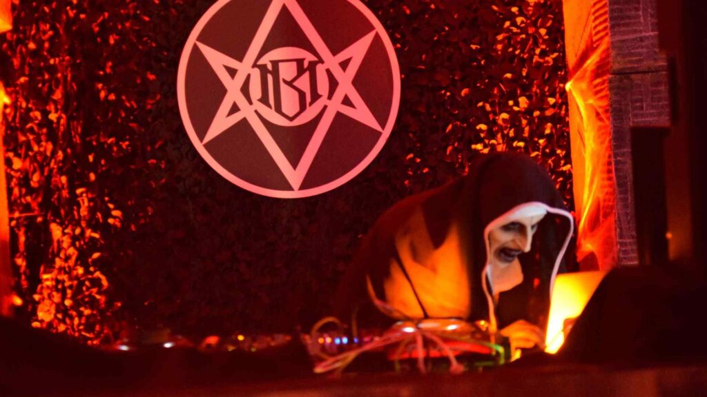 Spooky masked DJ performing set on 'Illuminati' style DJ set.