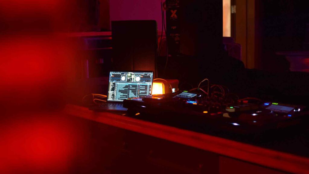 DJ technical set-up including macbook and mix tables.