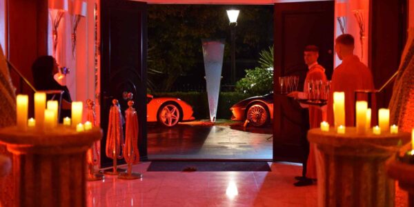 Front entrance of Halloween mansion party with bar tenders either side of entrance. Guests would get a welcome drink as they entered the space.