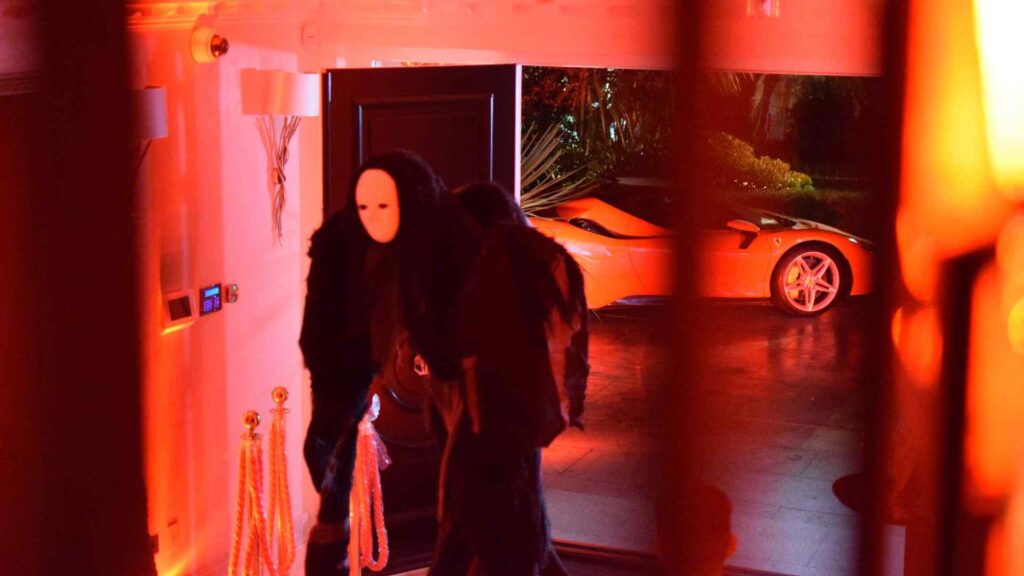 Faceless 7ft stilt walker performer entering main space of Halloween 'Cult Awakening' themed event.