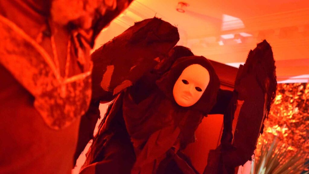 Close-up of 7ft faceless stilt walker Halloween entertainer.