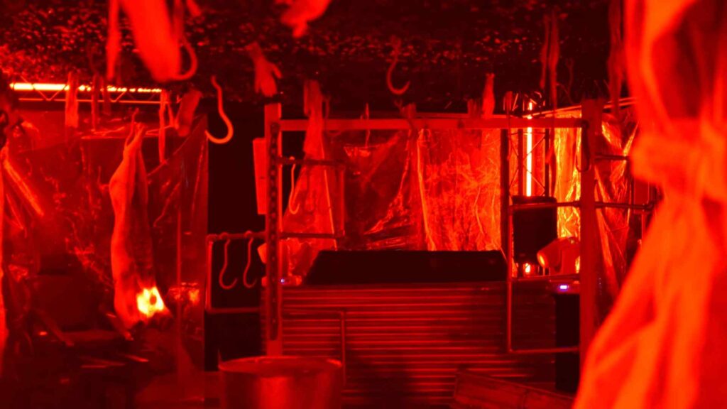Main 'slaughterhouse' room complete with DJ set, hanging props and decorations, projection lighting and more.