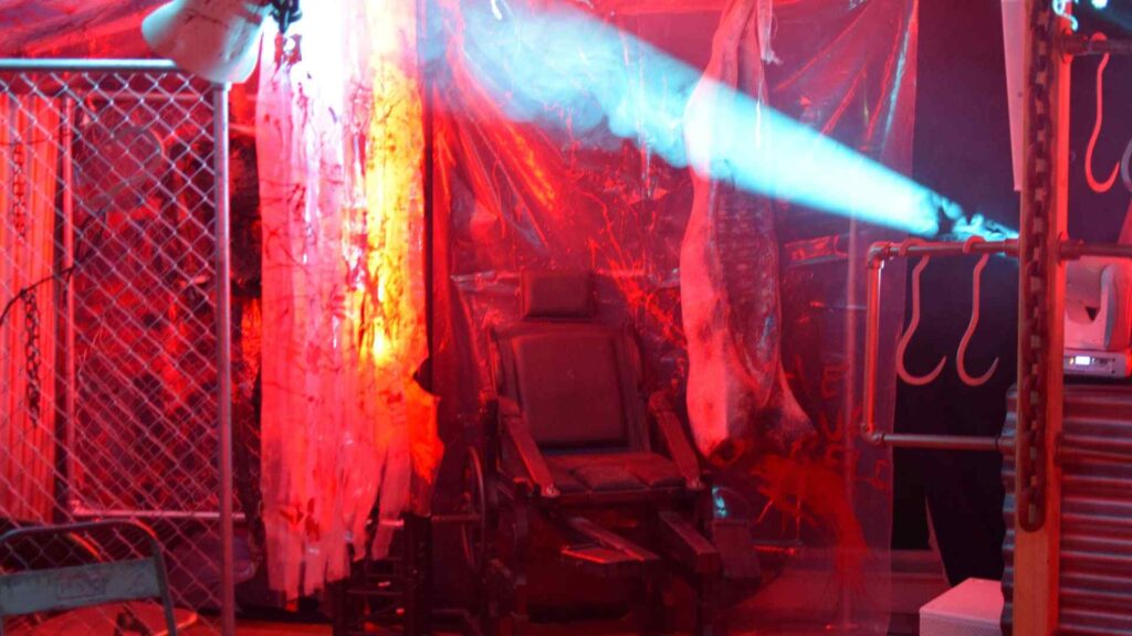 Cult Awakening Halloween Mansion Party 'slaughterhouse' style room complete with bespoke props and decorations including vintage dental chair.