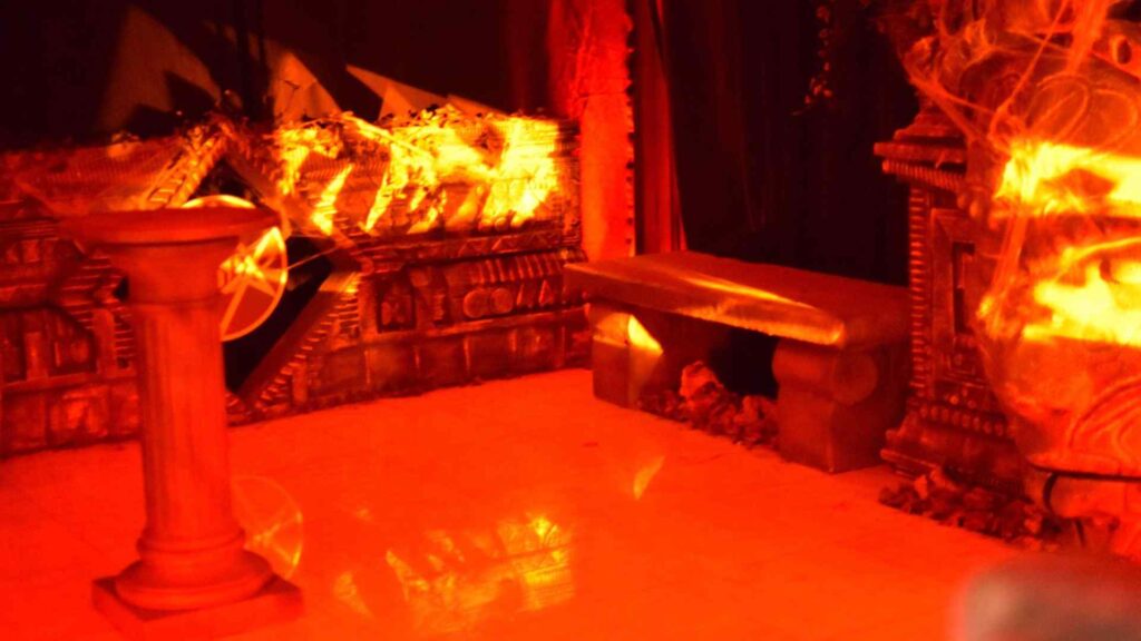 Bespoke stone-style seating to compliment temple theme in this area of the Halloween mansion party.