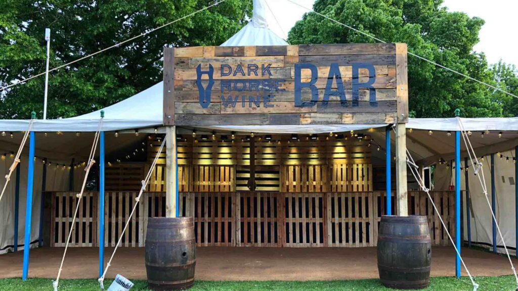 A bespoke branded outdoor event space we created using recycled pallet wood. Incorporating brand signage and covered tent design. 